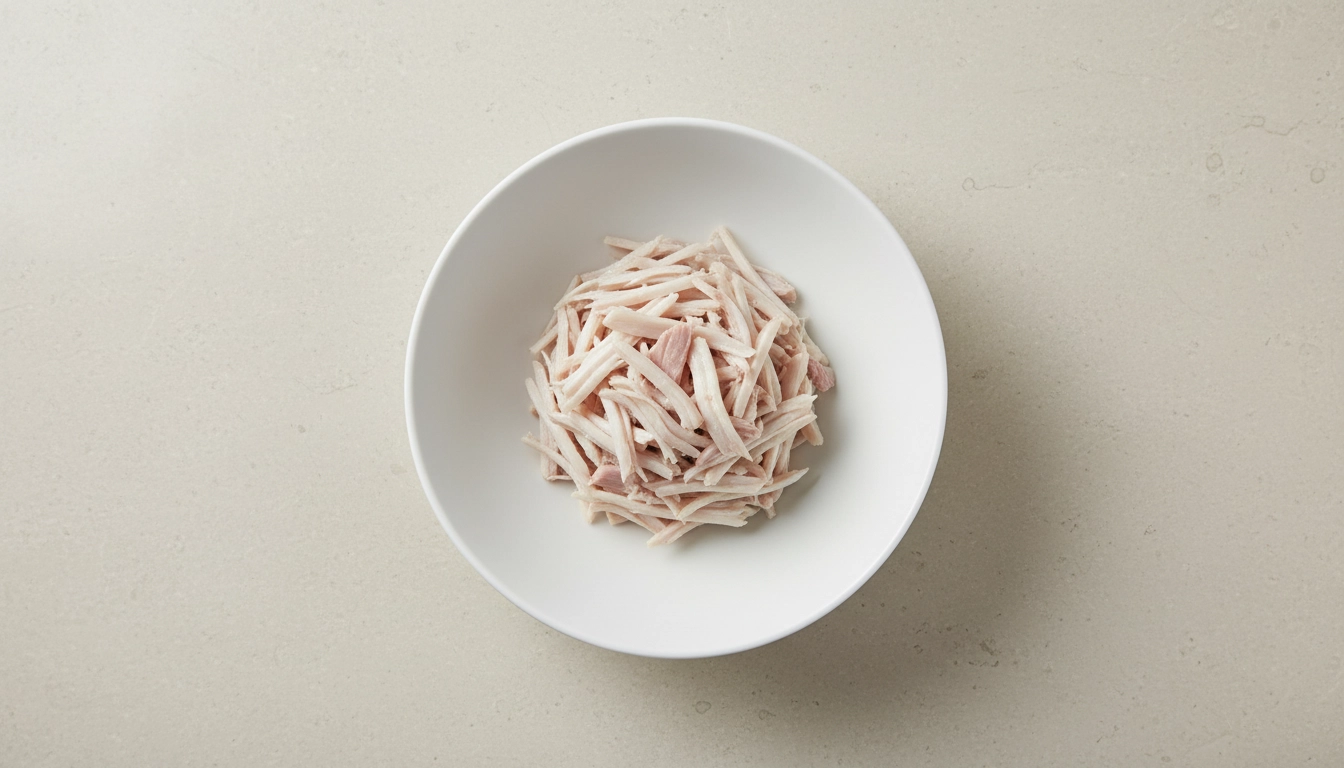 A clean white bowl containing a single-protein source, representing the best wet cat food for sensitive stomachs.